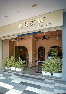 a store front of a building with plants in pots at Neu Suites Ampang near LRT Jelatek in Kuala Lumpur