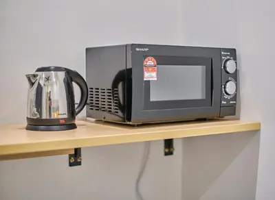 a microwave and a toaster on a shelf at Neu Suites Ampang near LRT Jelatek in Kuala Lumpur