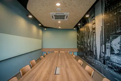 a conference room with a long table and chairs at Neu Suites Ampang near LRT Jelatek in Kuala Lumpur