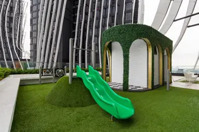 a playground with a green slide in a building at Arena Gaming Suite In Arte Mont Kiara in Kuala Lumpur