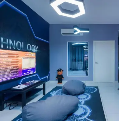 a blue room with a bean bag chair and a monitor at Arena Gaming Suite In Arte Mont Kiara in Kuala Lumpur