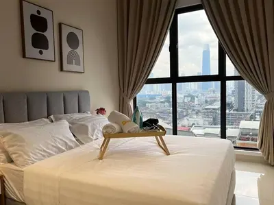 a bedroom with a bed with a table on it at 3R3B KLCity CentreView (Balcony) - 8 pax in Kuala Lumpur