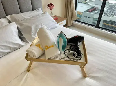 a tray with towels and other items on a bed at 3R3B KLCity CentreView (Balcony) - 8 pax in Kuala Lumpur