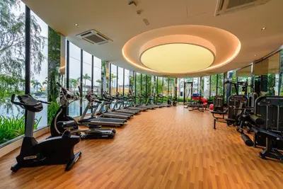a gym with a row of treadmills and ellipticals at Trion Premier Suites Kuala Lumpur in Kuala Lumpur