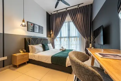 a bedroom with a bed and a desk and a window at Trion Premier Suites Kuala Lumpur in Kuala Lumpur