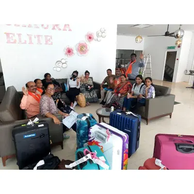 a group of people sitting in a room with luggage at Sakura Elite Kuala Lumpur in Kuala Lumpur