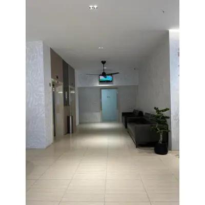 a living room with a couch and a blue door at Sakura Elite Kuala Lumpur in Kuala Lumpur