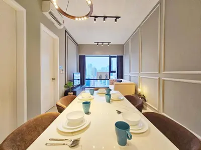 a dining room with a white table and chairs at Axon Suite Bukit Bintang 3Bed Room Suites ,5min Pavillion KL in Kuala Lumpur