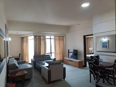 a living room with a couch and a tv at Times Square Apartment By Skyline in Kuala Lumpur