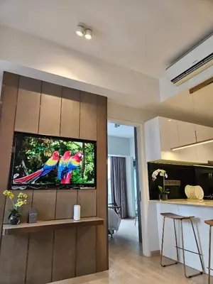 a living room with two macaws on the tv screen at Star Residence Pool View 2br Unit Floor 8 in Kuala Lumpur