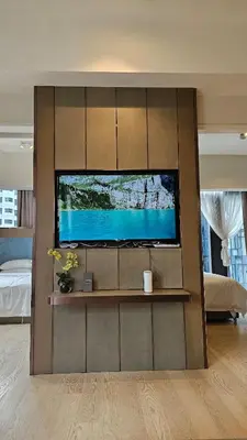 a living room with a flat screen tv on a wall at Star Residence Pool View 2br Unit Floor 8 in Kuala Lumpur
