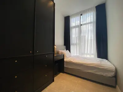 a bedroom with a bed and a dresser and a window at The Axon Bukit Bintang Residence by De Space in Kuala Lumpur