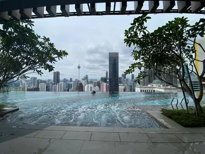 a swimming pool with a city skyline in the background at The Axon Bukit Bintang Residence by De Space in Kuala Lumpur