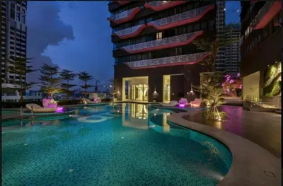 a swimming pool in front of a building at FHS Homestay @ Arte Plus Jalan Ampang T1-40-02 in Kuala Lumpur