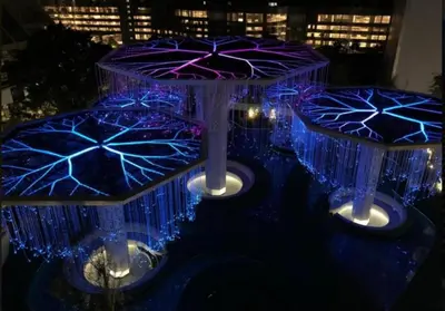 a group of umbrellas are lit up at night at FHS Homestay @ Arte Plus Jalan Ampang T1-40-02 in Kuala Lumpur