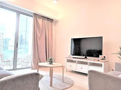 a living room with a large television and a table at Suasana Suites KLCC Bukit Ceylon in Kuala Lumpur