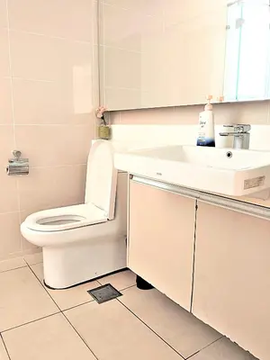 a bathroom with a toilet and a sink at Suasana Suites KLCC Bukit Ceylon in Kuala Lumpur