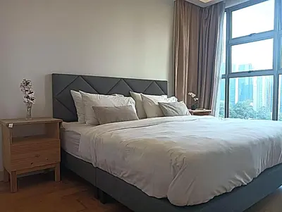a bedroom with a large bed and a window at Suasana Suites KLCC Bukit Ceylon in Kuala Lumpur