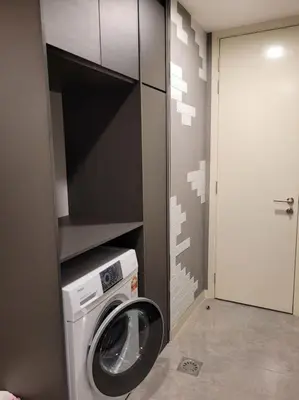a laundry room with a washing machine in a room at OOAK Residence at Mont Kiara in Kuala Lumpur