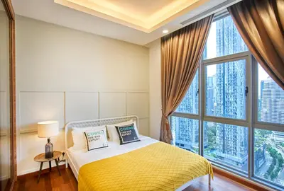 a bedroom with a bed and a large window at Royce Residence KLCC by Cobnb in Kuala Lumpur