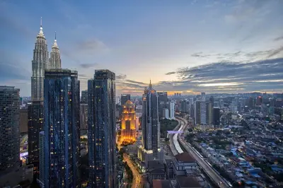 a view of a city at night with tall buildings at Royce Residence KLCC by Cobnb in Kuala Lumpur