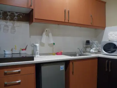 a kitchen with a sink and a microwave at Maytower Apartment in Kuala Lumpur
