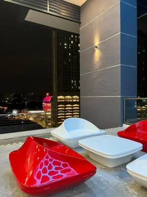 two red and white toilets sitting on top of a building at KL Sunway Velocity 1-5pax connected to Mall & MRT in Kuala Lumpur