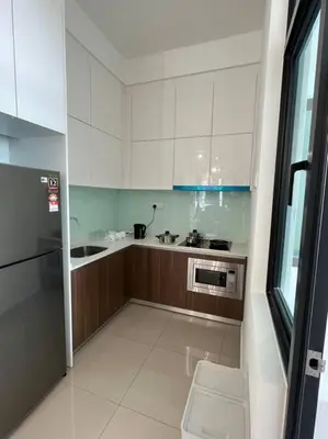 a kitchen with white cabinets and a sink and a microwave at KL Sunway Velocity 1-5pax connected to Mall & MRT in Kuala Lumpur
