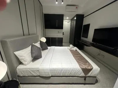 a bedroom with a bed and a flat screen tv at Axon Bukit Bintang By Moonlight in Kuala Lumpur