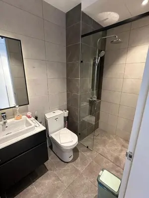 a bathroom with a shower and a toilet and a sink at Axon Bukit Bintang By Moonlight in Kuala Lumpur