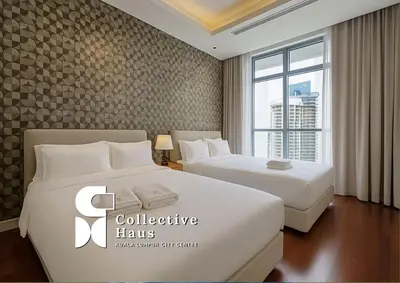 a hotel room with two beds and a window at Royce Residence KLCC Kuala Lumpur by Collective Haus in Kuala Lumpur