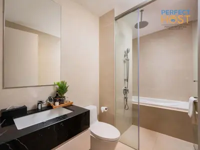 a bathroom with a toilet and a sink and a shower at Pavilion Ceylon Hill Suites, KLCC in Kuala Lumpur
