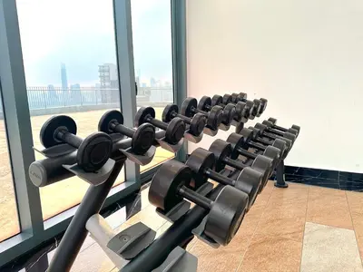 a row of exercise equipment in a gym at 3 Towers Jalan Ampang By Serenity Vacation Homes in Kuala Lumpur