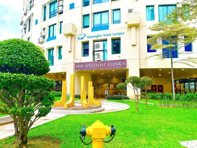 a yellow fire hydrant in front of a building at 3 Towers Jalan Ampang By Serenity Vacation Homes in Kuala Lumpur