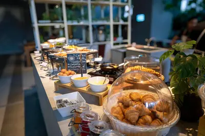 a buffet with bread and pastries on a table at Ceylonz Suite Kuala Lumpur Bukit Bintang in Kuala Lumpur
