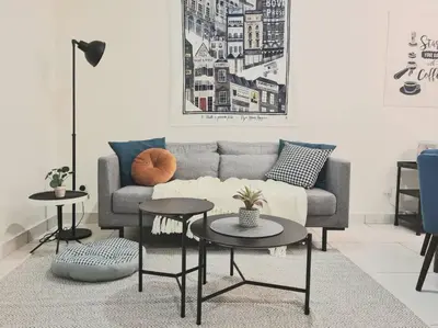 a living room with a couch and two tables at Designer Studio Arte Mont Kiara in Kuala Lumpur