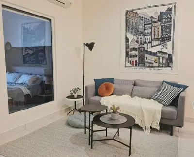 a living room with a couch and two tables at Designer Studio Arte Mont Kiara in Kuala Lumpur