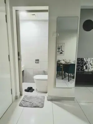 a bathroom with a tub and a toilet and a table at Designer Studio Arte Mont Kiara in Kuala Lumpur