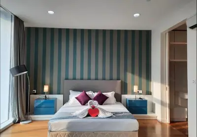 a bedroom with a bed with a teddy bear on it at The Platinum KLCC By Victoria Home in Kuala Lumpur