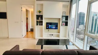 a living room with a couch and a tv at The Platinum KLCC By Victoria Home in Kuala Lumpur