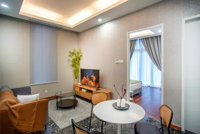 a living room with a couch and a tv and a table at Royce Residence KLCC, Kuala Lumpur City Center, COBNB in Kuala Lumpur