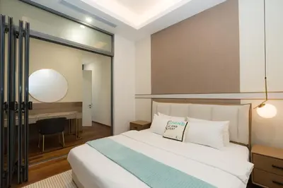a bedroom with a white bed and a desk at Royce Residence KLCC, Kuala Lumpur City Center, COBNB in Kuala Lumpur