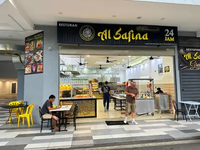 a restaurant with people sitting at tables in front of it at Neu Suites Service Apartment in Kuala Lumpur