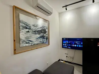 a living room with a painting on the wall at Neu Suites Service Apartment in Kuala Lumpur