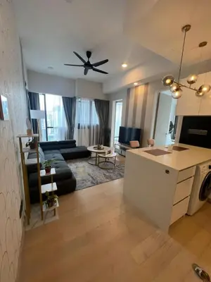 a living room with a couch and a ceiling fan at Star Residence Klcc By M&T in Kuala Lumpur