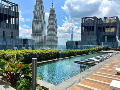 a view of the petronas twin towers from the city at Star Residence Klcc By M&T in Kuala Lumpur