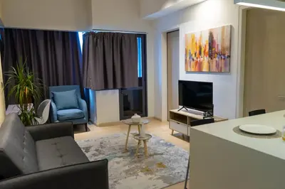 a living room with a couch and a television at Star Residence Klcc By M&T in Kuala Lumpur