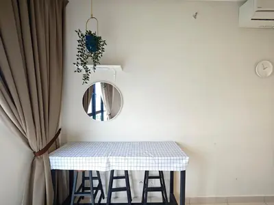 a table with stools and a mirror on a wall at TRION Studio 4 PAX Teneighth in Kuala Lumpur