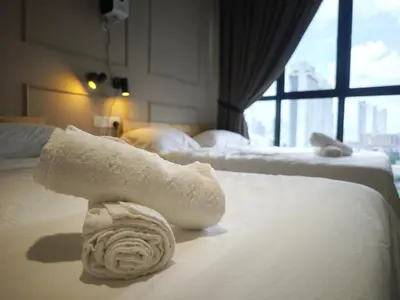 a towel on a bed in a hotel room at TRION Studio 4 PAX Teneighth in Kuala Lumpur