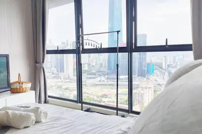 a bed in a room with a large window at Central KL Retreat MyTown Ikea KLCC TRX Mall MRT in Kuala Lumpur
